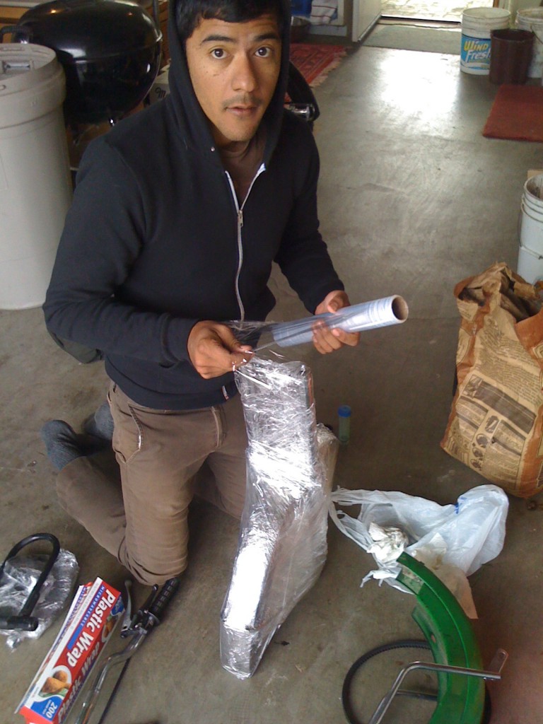 Anup wrapping his entier 103 in saran wrap for the car ride home.